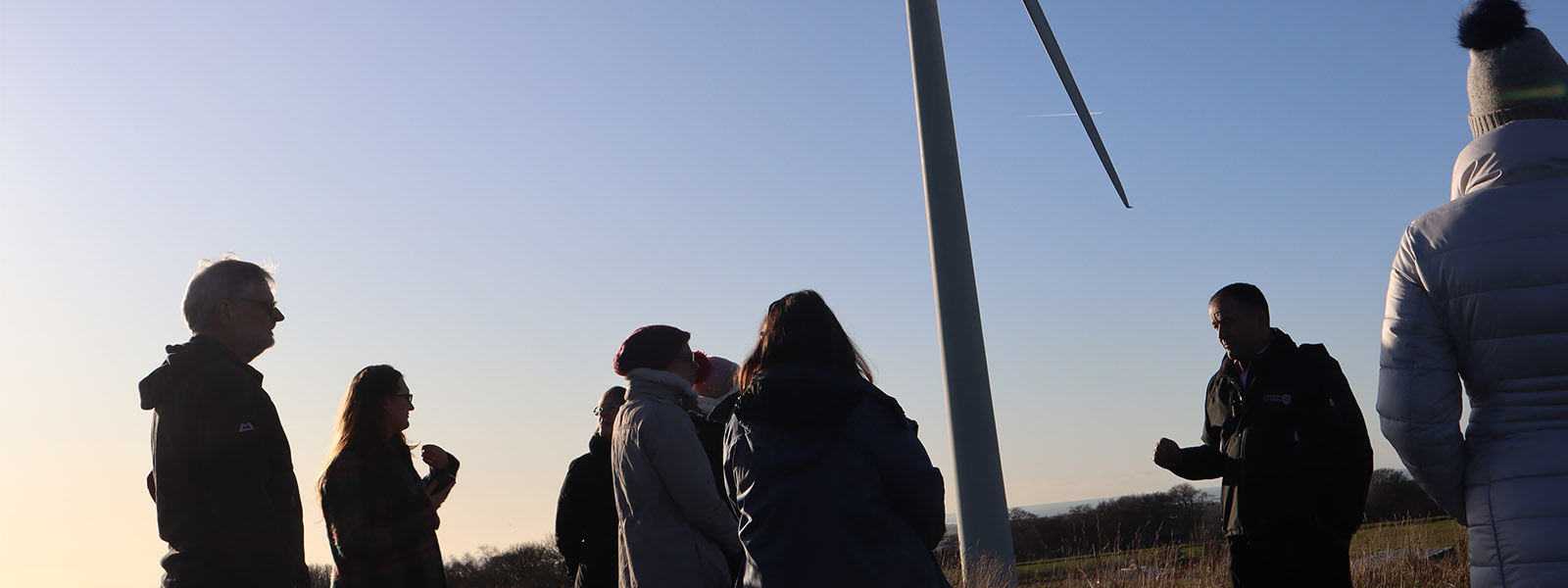 ϲʿ's wind turbine with people attending a talk on sustainability.